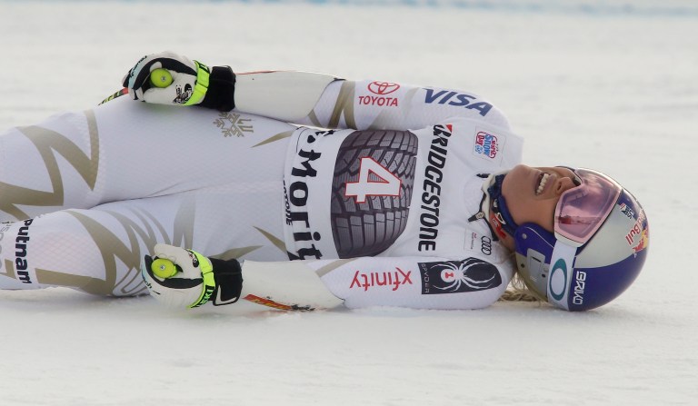 United States' Lindsey Vonn grimaces in pain after getting to the finish area after completing an alpine ski, women's World Cup super-G, in St. Moritz, Switzerland. (AP Photo/Giovanni Auletta)