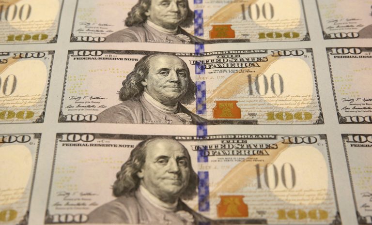 FILE - This Sept. 24, 2013 file photo shows a sheet of uncut $100 bills as they make their way through the printing process at the Bureau of Engraving and Printing Western Currency Facility in Fort Worth, Texas. The new $100 bill, with a number of an array of high-tech features designed to thwart counterfeiters, will finally get its coming out party on Tuesday, partial government shutdown or not. The Federal Reserve, which has not been affected by the shutdown, will have armored trucks rolling from its regional banks around the country headed to banks, savings and loans and other financial institutions with the new C-notes. (AP Photo/LM Otero, File)