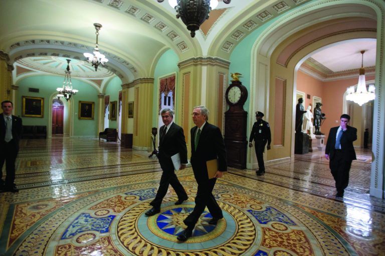 Sen. Mike Johanns, R-Neb., left, walks with Senate Minority Leader Mitch McConnell from Kentucky, to the Senate floor for a vote on the fiscal cliff, on Capitol Hill Tuesday, Jan. 1, 2013 in Washington. The Senate passed legislation early New Year's Day to neutralize a fiscal cliff combination of across-the-board tax increases and spending cuts that kicked in at midnight. (AP Photo/Alex Brandon)