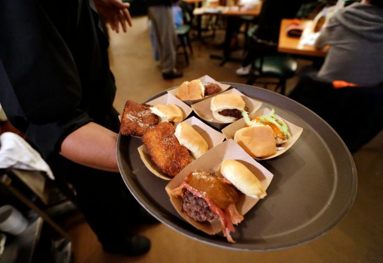 In this Jan. 28, 2014 photo, sliders are sent out from the kitchen at the Green Dot Stables, in Detroit. The Institute for Supply Management, a trade group of purchasing managers, issues its index of non-manufacturing (service-sector) activity for January, on Wednesday, Feb. 5, 2014. (AP Photo/Carlos Osorio)
