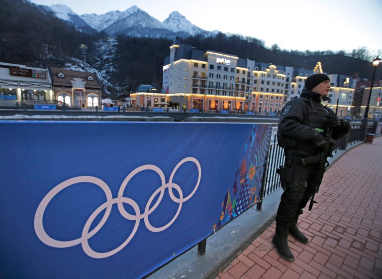 An armed Russian security guard stands at the ski resort Rosa Khutor, where the snow and sliding sports venues for the 2014 Winter Olympics are located, Tuesday, Feb. 4, 2014, in Krasnaya Polyana, Russia. (AP Photo/Dita Alangkara)