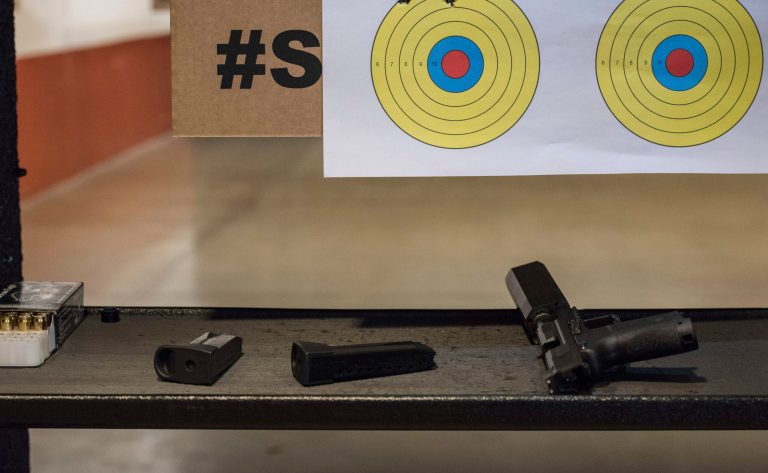 In this Jan. 28, 2017, photo, a firearm, magazines and a suppressor rest on a table at a gun range in Atlanta, Georgia. Gun rights advocates entered the Trump era with high hopes. After years of frustration they thought a gun-friendly president and Congress would advance their agenda. (AP Photo/Lisa Marie Pane)