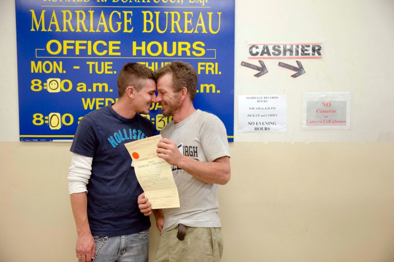 William Roletter, left, and Paul Rowe, press close to one another after they had their photo made with their newly acquired marriage certificate, Wednesday, May 21, 2014, at City Hall in Philadelphia. (AP Photo/Matt Rourke)