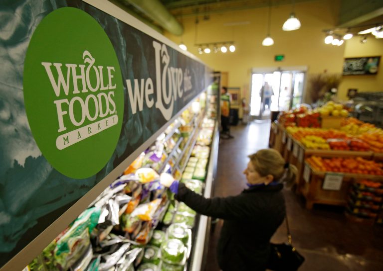 In this March 27, 2014 photo, a woman shops at the Whole Foods Market in Woodmere Village, Ohio. Whole Foods reports quarterly financial results on Wednesday, July 30, 2014.