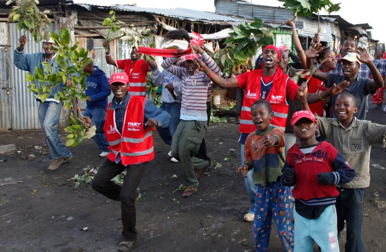 Supporters of Kenyan presidential candidate Uhuru Kenyatta celebrate in Nairobi, Kenya Saturday, March 9, 2013. Kenya's election commission posted complete results early Saturday showing that Deputy Prime Minister Uhuru Kenyatta prevailed in the country's presidential elections by the slimmest of margins, winning 50.03 percent of the vote.(AP Photo/Sayyid Azim)