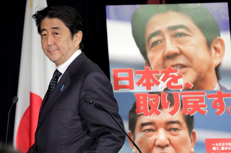   FILE - Nov. 16, 2012 file photo, Japan's largest opposition Liberal Democratic Party leader Shinzo Abe arrives for a press conference in Tokyo after the lower house of parliament was dissolved. The LDPâs victory in Japanâs parliamentary election Sunday, Dec. 16 virtually ensures that Abe, who resigned as prime minister for health reasons in 2007 after just a year in office, will get a second chance to try to lead Japan out of its economic slump. The slogan on the poster reads: We get back Japan. (AP Photo/Koji Sasahara, File)  