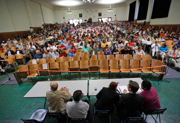 Town residents listen during a presentation by federal officials involved in the placement of immigrant children at St Paul's College in Lawrenceville, Va., Thursday, June 19, 2014. The program is on hold pending comments from local residents (AP Photo/Steve Helber)