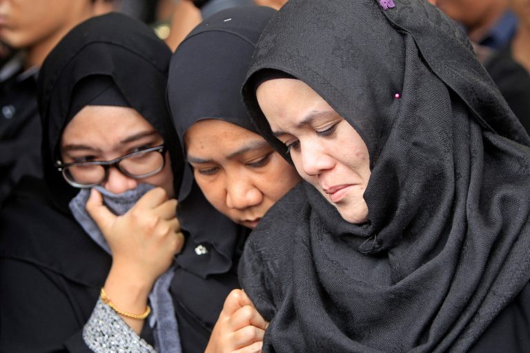 Family members of Nur Shazana, a Malaysia Airlines crew member who was among the victims onboard Flight MH17, cry during a burial ceremony at Taman Selatan Muslim cemetery in Putrajaya, Malaysia, Friday, Aug. 22, 2014. Carried by soldiers and draped in the national flag, coffins carrying Malaysian victims of Flight MH17 returned home Friday to a country still searching for those onboard another doomed jet and a government battling the political fallout of the twin tragedies. (AP Photo/Lai Seng Sin)