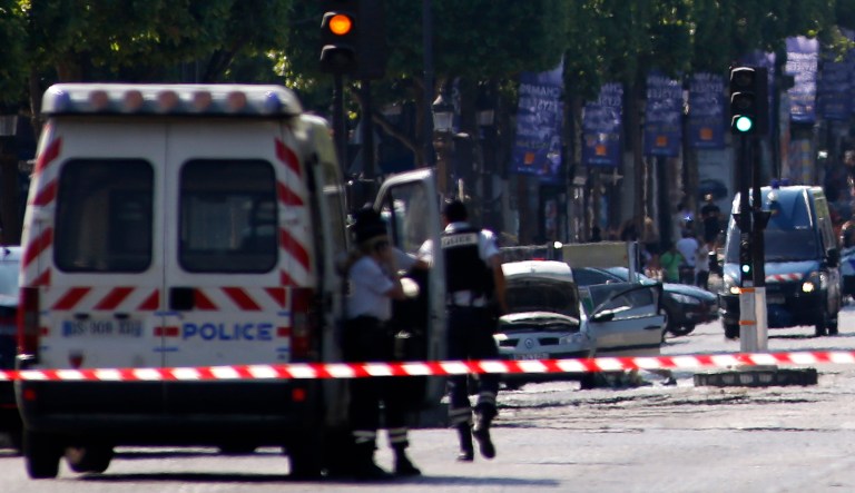 Police forces secure the area on the Champs Elysees next to the suspected car, center, in Paris, Monday, June 19, 2017. (AP Photo/Matthieu Alexandre)