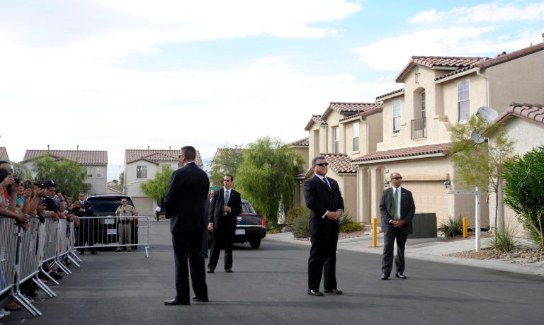 Secret Service agents stand guard as President Barack Obama meets with homeowners in suburban Las Vegas in 2012.(AP Photo/Susan Walsh)