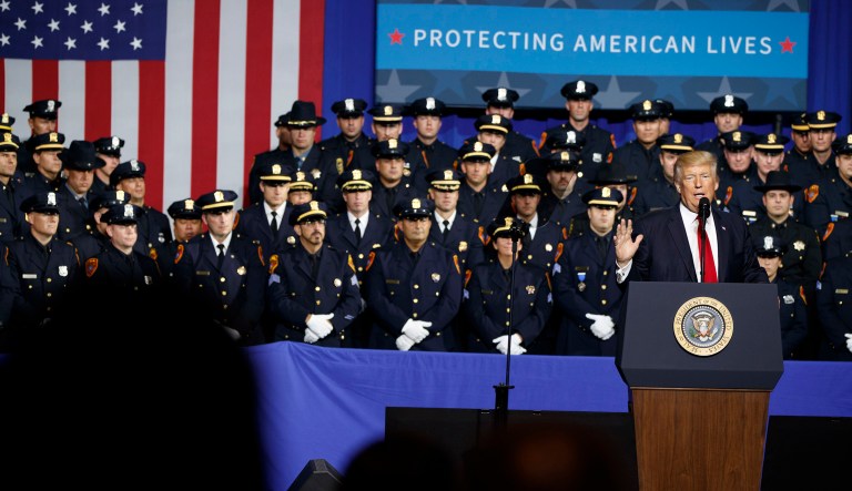 He said to officers while describing a police officer taking a suspect into custody in the back of a police car. (AP Photo/Evan Vucci)