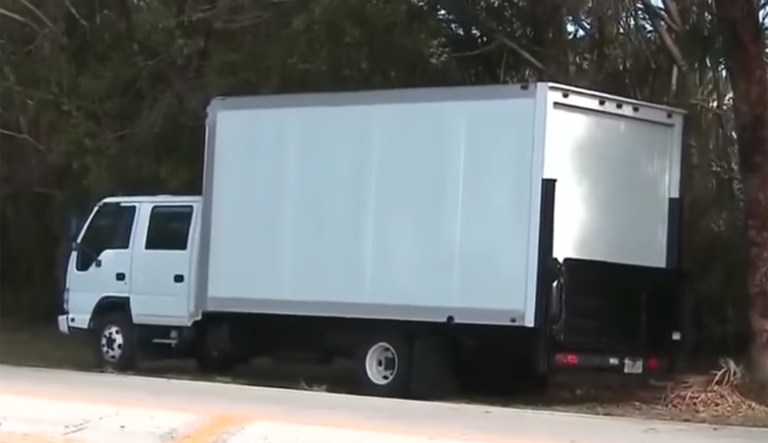 The white truck blocking CNN's view of the West Palm Beach, Fla., course appeared earlier this week after the promoted an exclusive video of the president golfing. (Image courtesy screenshot)