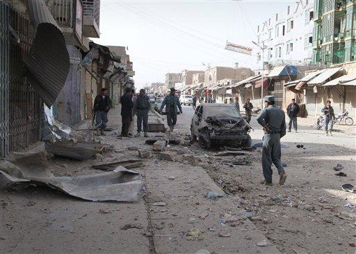 A damaged car is seen at the scene of an explosion in Kandahar, south of Kabul, Afghanistan, Tuesday, Dec. 6, 2011. A bomb exploded and injured 6 Afghans, police officials said. (AP Photo/Allauddin Khan)