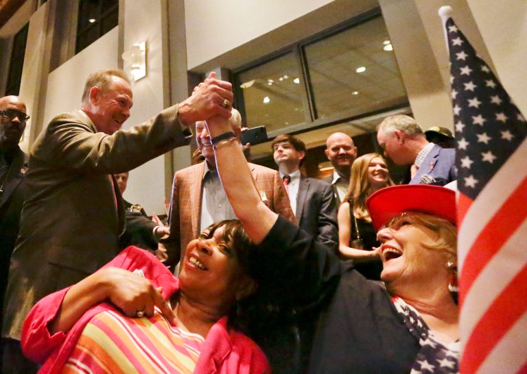 Former Alabama Chief Justice and U.S. Senate candidate Roy Moore, greets supporter, Patricia Jones, right, before his election party on Sept. 26 in Montgomery, Ala. (AP Photo/Brynn Anderson)