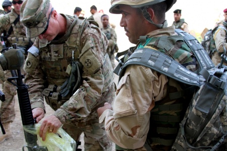 Col. Michael Midkiff, 310th Sustainment Command (Expeditionary) and officer-in-charge of the 1st Sustainment Command (Theater) Logistics Advise and Assist Team from Fort Bragg, N.C., helps an Iraqi soldier unwrap an M16A2 rifle he received as part of the fielding of combat brigade sets supplied to Iraqi Security Forces in support of Combined Joint Task Force - Operation Inherent Resolve May 25, 2015, at Camp Taji, Iraq. (Capt. A. Sean Taylor, 310th A&A, CJTF-OIR Public Affairs)