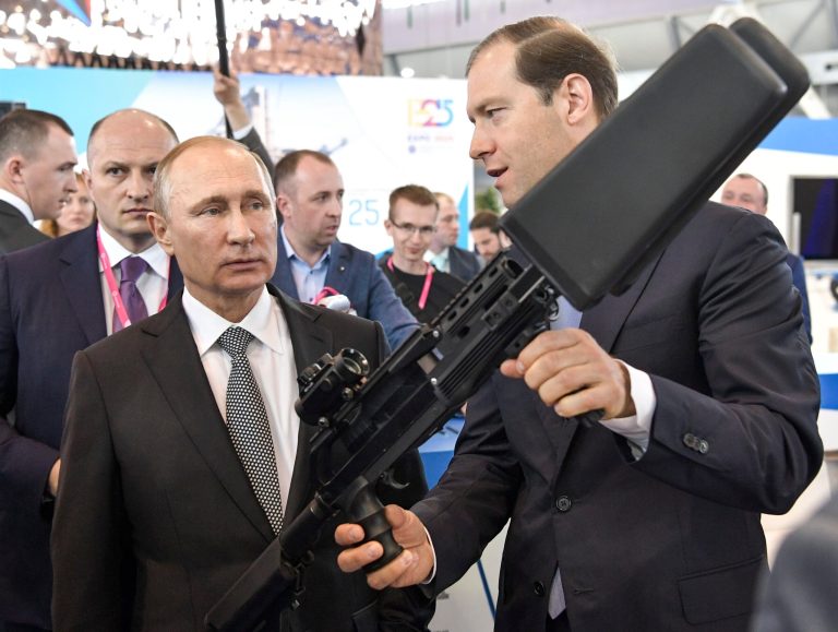 Russian Minister of Industry and Trade Denis Manturov, right, shows at exhibit to Russian President Vladimir Putin at the Innoprom International Industrial Trade Fair in Yekaterinburg, Russia, Monday, July 10, 2017. (Alexei Nikolsky, Kremlin Pool Photo via AP)