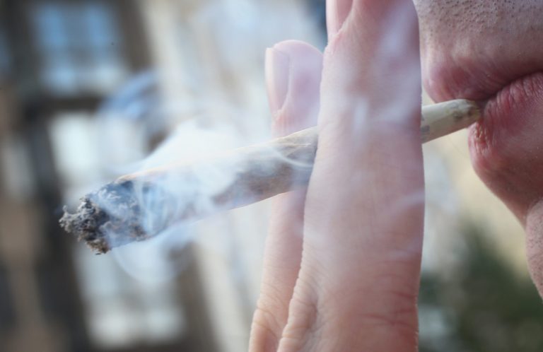 A participant smokes a marijuana joint while marching in the annual Hemp Parade (Hanfparade) on Aug. 9, 2014 in Berlin, Germany. (Photo by Sean Gallup/Getty Images)