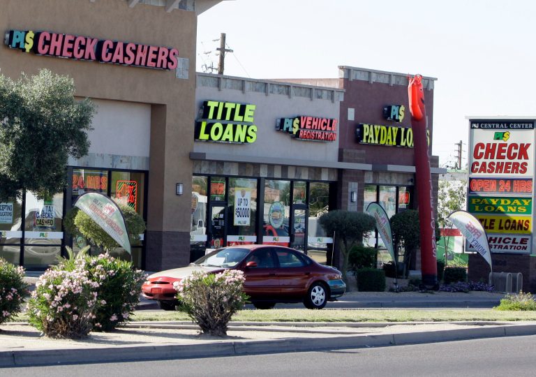 Payday loan businesses, some of them open 24 hours a day, advertise their services in Phoenix on Wednesday, April 7, 2010, one of 650 operating in the state with some open 24 hours a day. (AP Photo/Ross D. Franklin)