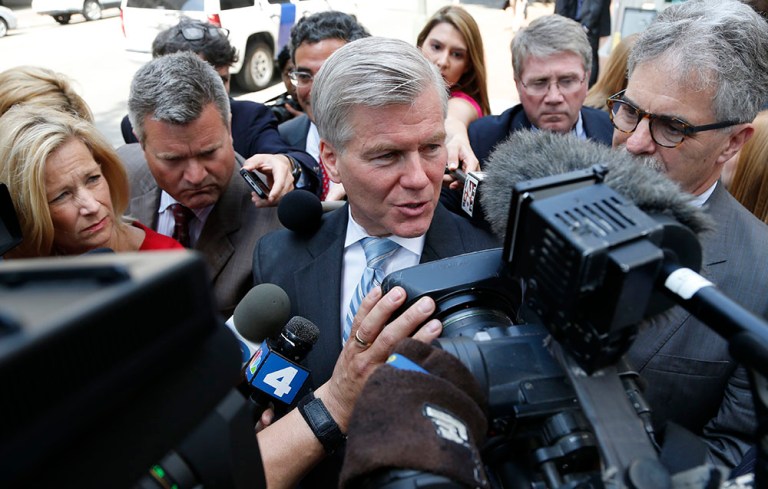 Former Virginia Gov. Bob McDonnell, center, answers reporters questions Tuesday, May 12, 2015. (AP Photo/Steve Helber)