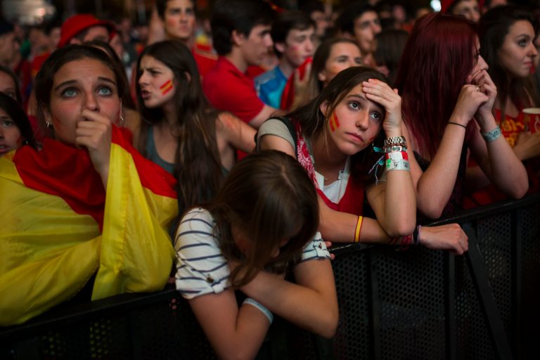Spanish soccer fans gesture as they watch on a giant display the World Cup soccer match between Spain and Chile, in Madrid, Spain, Wednesday, June 18, 2014. (AP Photo/Andres Kudacki)