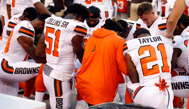 Members of the Cleveland Browns kneel during the national anthem before an NFL preseason football game. (AP Photo/Ron Schwane)