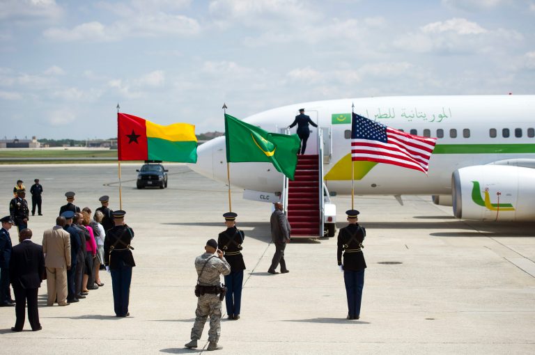 State Department, Air Force, Army and Secret Services members wait for the door to open on President Mohamed Ould Abdel Aziz of Mauritania's airplane at Andrews Air Force Base, Md., Monday, Aug. 4, 2014. President Barack Obama is gathering nearly 50 African heads of state in Washington for the US Africa Summit. (AP Photo/Cliff Owen)