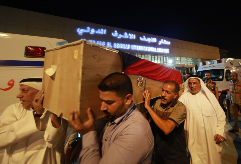A coffin draped with a Kuwaiti flag belonging to a victim of a suicide bombing that targeted a Shiite mosque in Kuwait on Friday, arrives to Najaf Airport for the funeral procession, in the Shiite holy city of Najaf, Iraq, onÂ Saturday, June 27, 2015. Kuwaiti authorities on Sunday identified the suicide bomber behind an attack on a Shiite mosque that killed more than two dozens as a Saudi citizen who flew into the Gulf nation just hours before he blew himself up. (AP Photo/ Jaber al-Helo)