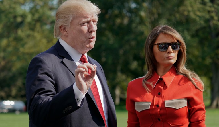 President Donald Trump stops to answers questions, accompanied by first lady Melania Trump, on at South Lawn of the White House in Washington, Sunday, Sept. 10, 2017. (AP Photo/Pablo Martinez Monsivais)