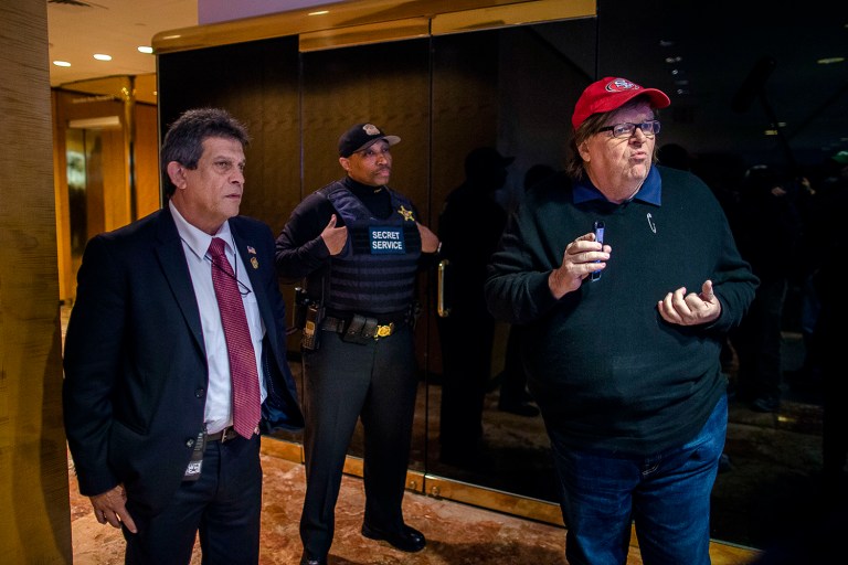Filmmaker Michael Moore, right, reacts as Secret Service block him to access to restricted areas inside Trump Tower in New York on Saturday. (AP Photo/Andres Kudacki)