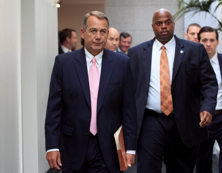   House Speaker John Boehner of Ohio, left, walks to join GOP House members for a caucus meeting on Capitol Hill in Washington, Tuesday, Sept. 10, 2013. Some conservative Republicans want to shut down the government if that's what it takes to block the 