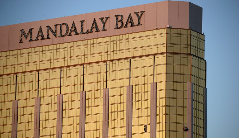 Drapes billow out of broken windows at the Mandalay Bay resort and casino Monday, Oct. 2, 2017, on the Las Vegas Strip following a deadly shooting at a music festival in Las Vegas. A gunman was found dead inside a hotel room. (AP Photo/John Locher)