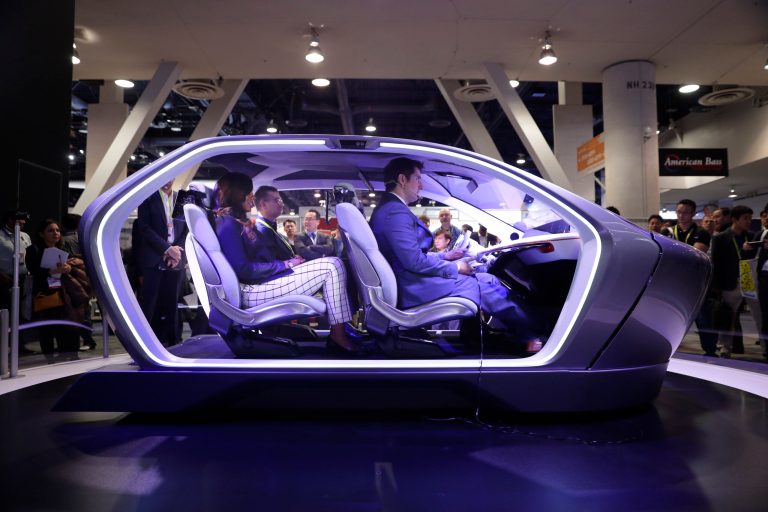 Show attendees sit in the Chrysler Portal self-driving concept car at CES International on Jan. 5 in Las Vegas. (AP Photo/Jae C. Hong)