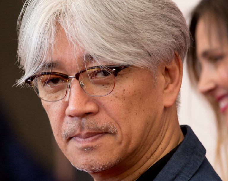 FILE - In this Wednesday, Aug. 28, 2013 file photo, jury member Ryuichi Sakamoto poses for photographers during the 70th edition of the Venice Film Festival, in Venice, Italy. Japanese musician Sakamoto has been diagnosed with throat cancer and has canceled his upcoming performances to focus on his health. (AP Photo/Andrew Medichini, File)