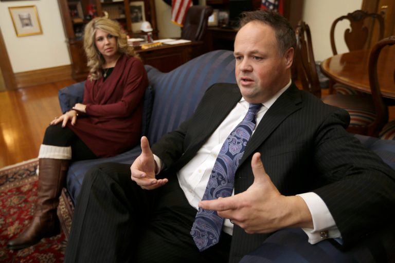 Arkansas Lt. Gov. Mark Darr, right, is interviewed at the Arkansas state Capitol in Little Rock, Ark., as his wife Kim listens Tuesday, Jan. 7, 2014. Darr said he won't resign over ethics violations tied to his campaign and office spending, despite growing calls for him to step down or face the threat of impeachment. (AP Photo/Danny Johnston)