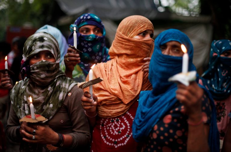 Activists hold candles during a vigil to protest against the gang rape of two teenage girls, in New Delhi, India, Saturday, May 31, 2014. Police arrested a third suspect and hunted for two others Saturday in the gang rape and slaying of two teenage cousins found hanging from a tree in Katra village, in the northern Indian state of Uttar Pradesh, a case that has prompted national outrage. (AP Photo/Altaf Qadri)