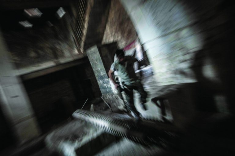 In this Monday, Oct. 29, 2012 photo, a rebel fighter belonging to the Qatebee Sokor Al-Islam group sneaks through a residential building as he looks for a firing position during clashes between rebel fighters and the Syrian army in the Jedida district of Aleppo, Syria. Syrian fighter jets pounded rebel areas across the country on Monday with scores of airstrikes that anti-regime activists called the most widespread bombing in a single day since Syria's troubles started 19 months ago.(AP Photo/Narciso Contreras).