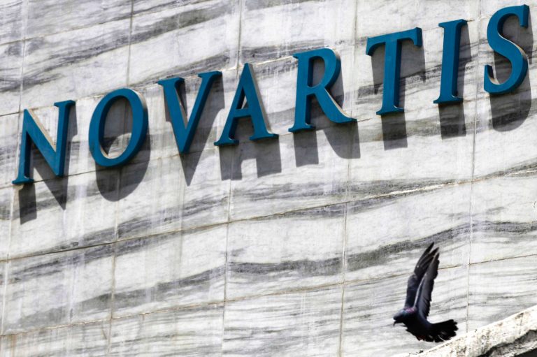 FILE - In this April 1, 2013 file photo, a dove flies near the logo of Novartis India Limited at their head office in Mumbai, India. A new study released Saturday, Aug. 30, 2014, shows an experimental Novartis drug, which does not have a name, lowered the chances of death or hospitalization by about 20 percent. (AP Photo/Rafiq Maqbool, File)