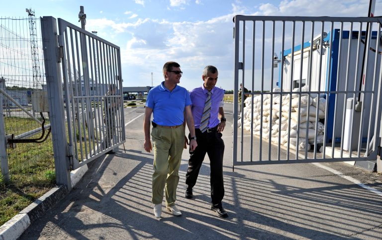 The head of the OSCE (Organization for Security and Cooperation in Europe) mission, acting Chief Observer Paul Picard, right, walks with Vadim Artyomov, deputy governor of Rostov region, left, while visiting the Gukovo border checkpoint at Russia-Ukraine border in a small town of Gukovo, 120 kms (75 miles ) from Rostov-on-Don, Russia, Wednesday, July 30, 2014. The mission will be based in the city of Kamensk-Shakhtinskiy, in the Rostov-on-Don region. (AP Photo/Sergei Pivovarov)