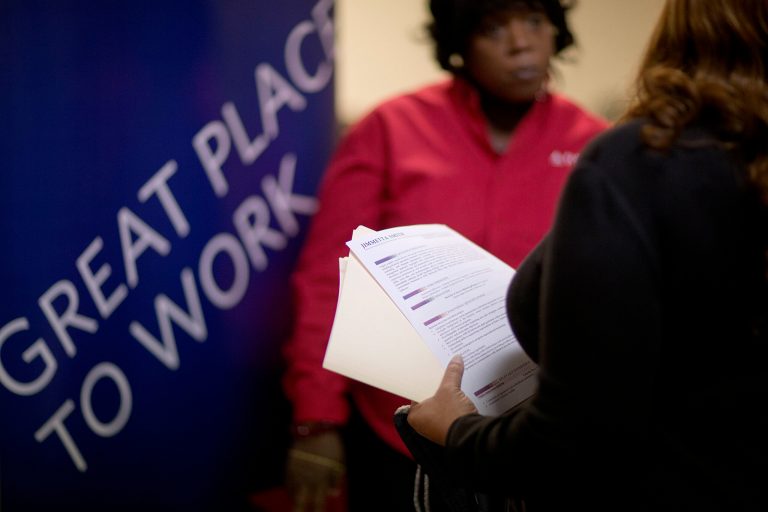 Jimmetta Smith holds her resume while talking with Rhonda Knight, a senior recruiter for Delta airlines, at a job fair for veterans and family members in Marietta, Ga. (AP/David Goldman)