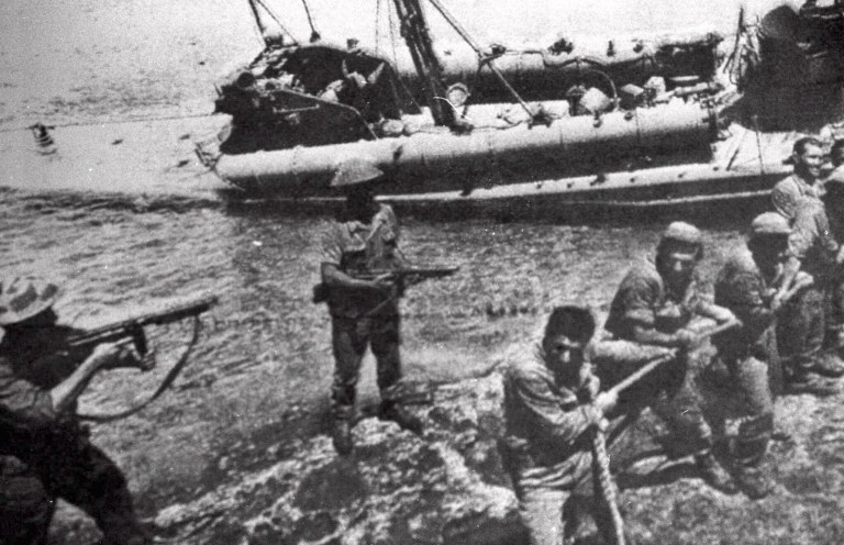 FILE- In this file photo dated July 20 1974, Turkish troops pull ashore a Greek Cypriot torpedo boat damaged during fighting in Kyrenia on the day Turkey invaded and occupied the northern third of Cyprus.  Europe's top human rights court on Monday May 12, 2014, ordered Turkey to pay 90 million euros ($123 million) to Cyprus over the 1974 invasion of the island and its subsequent division, in one of the largest judgments in its history, saying that the passage of time did not erase responsibility in the case. The judgment comes as the Turkish and Greek Cypriot communities are engaged in renewed efforts to reunite the island.(AP Photo, FILE)