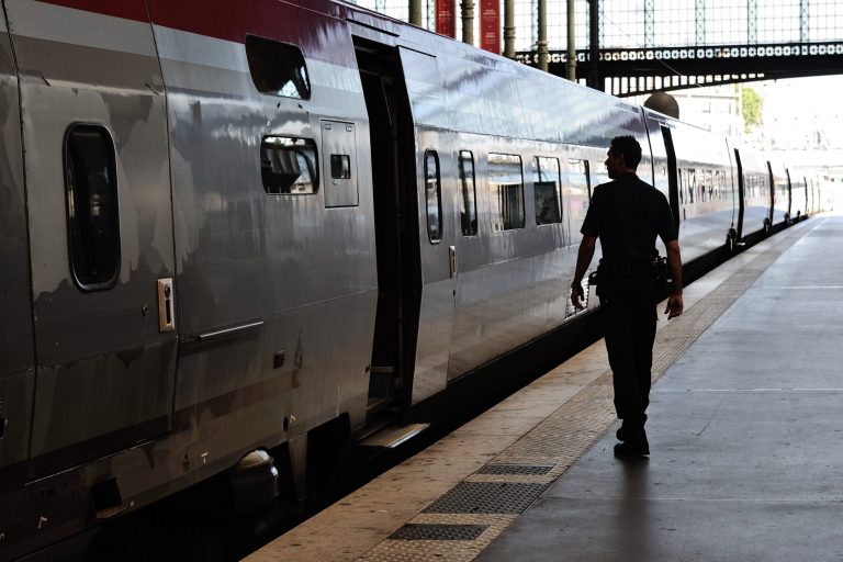 A French police officer patrols at Gare du Nord train station in Paris, France, Saturday, Aug. 22, 2015. A gunman prepared to open fire with an automatic weapon on a high-speed train traveling from Amsterdam to Paris on Friday, wounding several people before being subdued by passengers, officials said. (AP Photo/Binta)