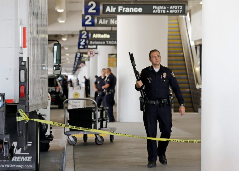 Police stand guard in Terminal 2 at Los Angeles International Airport on Friday, Nov. 1. A gunman armed with a semi-automatic rifle opened fire at the airport on Friday, killing a Transportation Security Administration employee and wounding two other people. Flights were disrupted nationwide. (AP Photo/Reed Saxon)