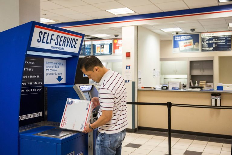 Fewer Americans are visiting the post office, preferring to use the Internet. (Photo by Andrew Burton/Getty Images)