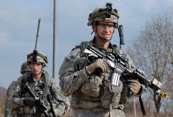 HOHENFELS, GERMANY - MARCH 19:  U.S. soldiers of the 173rd Airborne Brigade based in Vicenza, Italy, conduct a patrol through a mock Afghan village during a training exercise at the U.S. Army's Joint Multinational Readiness Center only weeks before the 173rd will deploy to Afghanistan on March 19, 2012 near Hohenfels, Germany. Though the Pentagon plans to possibly pull out two U.S. Army infantry brigades based in Germany in an effort to reduce costs, the U.S. military?s strong presence in Germany will likely continue, both due to the U.S. roll in NATO as well as the support the German bases provide for U.S. overseas military commitments.  (Photo by Johannes Simon/Getty Images)