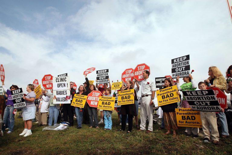 Protestors gather outside a Planned Parenthood clinic. (Scott Olson/Getty Images)