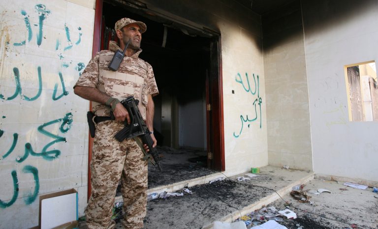 A Libyan military guard stands in front of one of the U.S. Consulate's burnt out buildings in Benghazi, Libya, on Sept. 14, 2012. (AP/Mohammad Hannon)