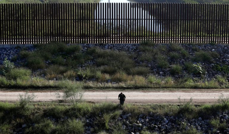 In this Wednesday, Nov. 16, 2016, photo, a U.S. Customs and Border Patrol agent searches for suspected illegal immigrants passing through the area in Hidalgo, Texas. (AP Photo/Eric Gay)