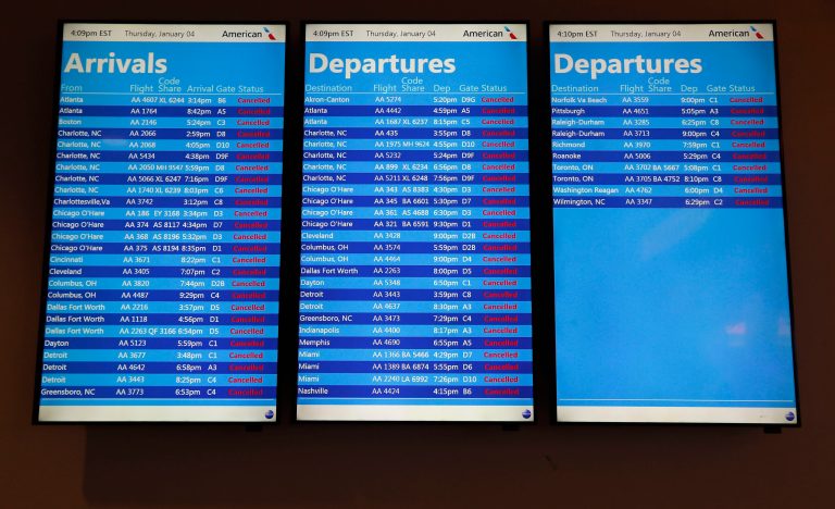 A flight status screen shows cancellations for all flights into and out of LaGuardia Airport, Thursday, Jan. 4, 2018, in New York. All flights have been suspended temporarily at JFK and LaGuardia airports due to wind and whiteout conditions. (AP Photo/Julie Jacobson)