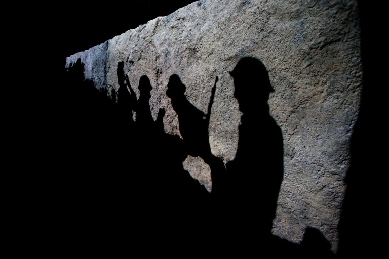 Silhouettes of British soldiers are projected onto a trench scene in the new 