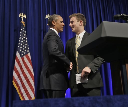 President Barack Obama, left, is introduced by Organizing for Action (OFA) field rep William Townsend, of Black Forest, Colo., before speaking at the event, Monday, July 22, 2013 in Washington. OFA was formed for the president's 2012 re-election campaign with the express goal of backing his policy priorities. (AP Photo/Pablo Martinez Monsivais)
